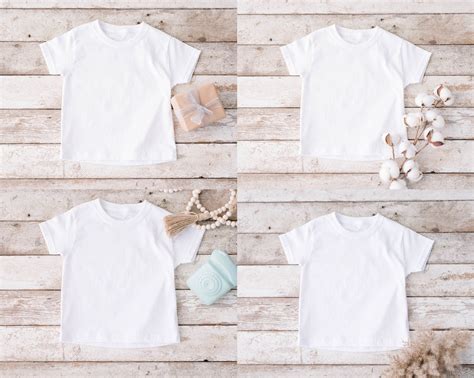 Download Kids White t-shirt mockup with gnomes on a wooden background.